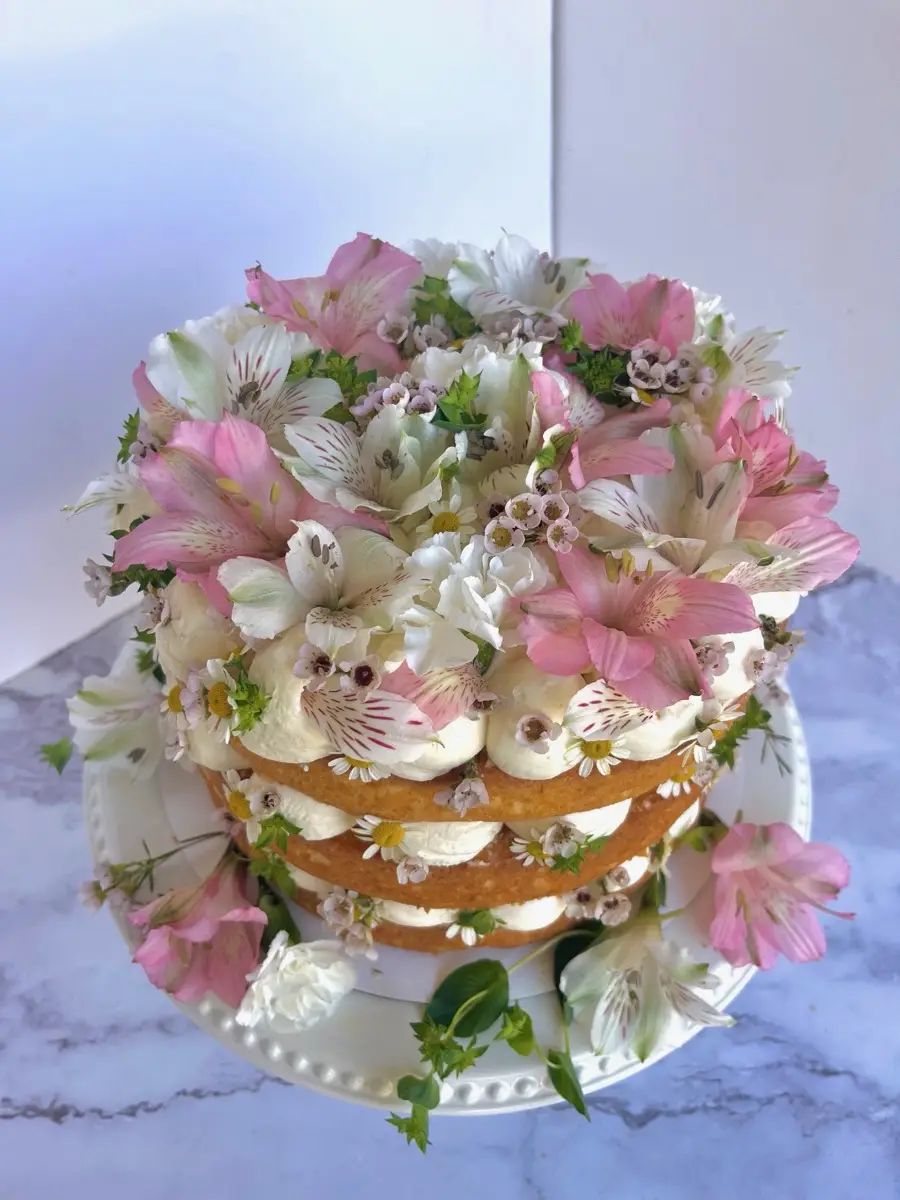Layered cake with pink alstroemeria and wax flowers