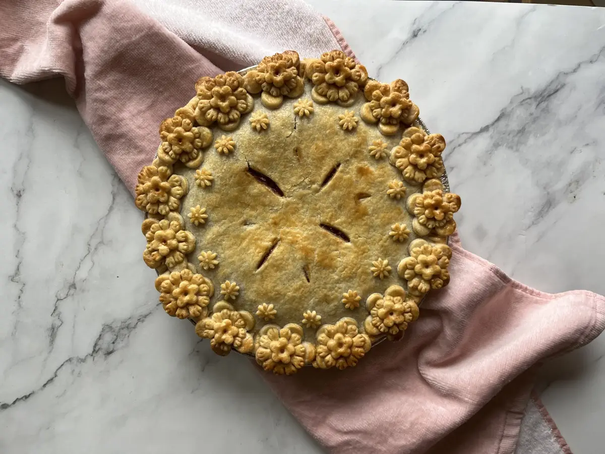 Classic baked pie with a delicate floral pastry border