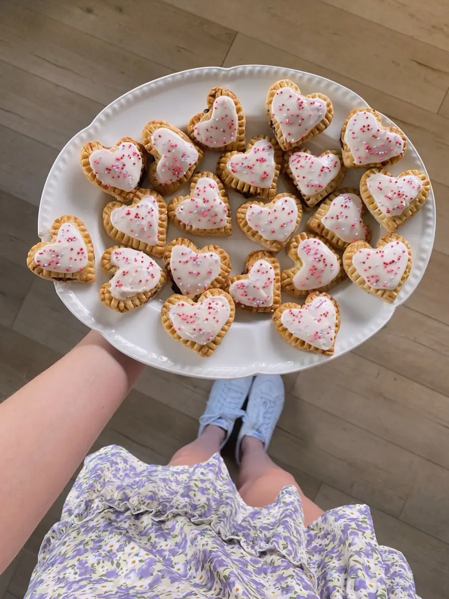 Homemade pop tarts with floral icing at a garden table setting